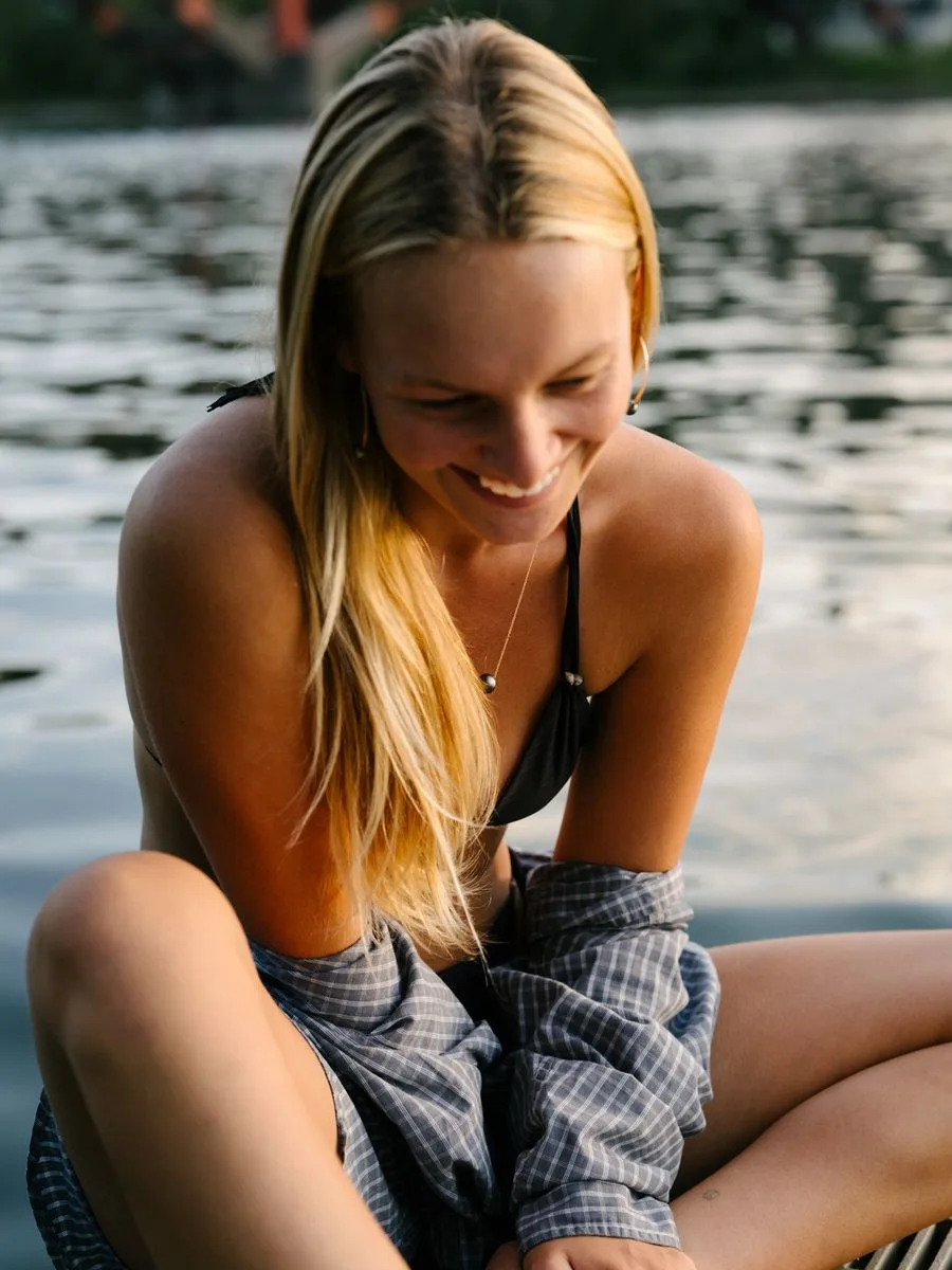 Image may contain Blonde Hair Person Face Head Photography Portrait Adult Happy Smile Accessories and Jewelry