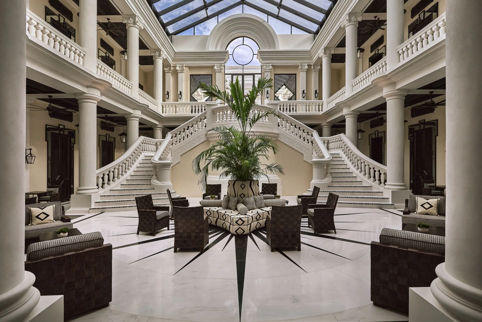 Image may contain Architecture Building Foyer Indoors Lamp Chair Furniture Plant and Couch